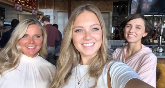 A group of people standing together and smiling