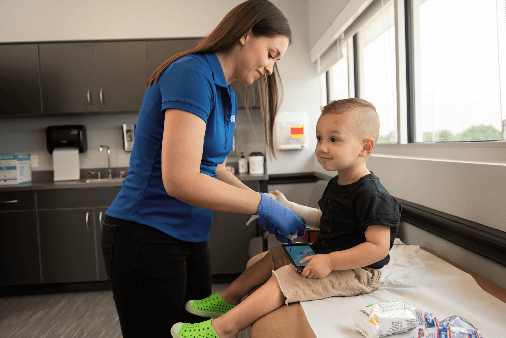 infant child getting cast on his arm 