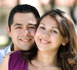 hispanic husband and wife smiling