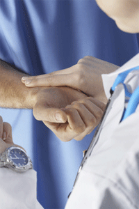 doctor checking a patient's pulse