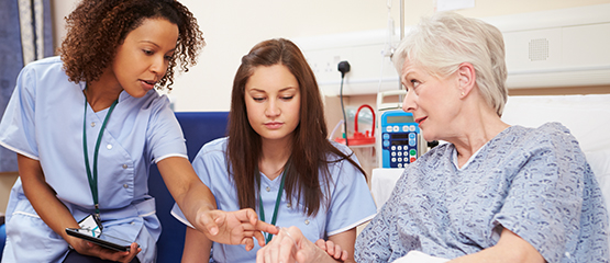 a nurse being trained how to insert an IV for a patient
