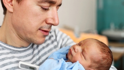 A man holding a newborn baby