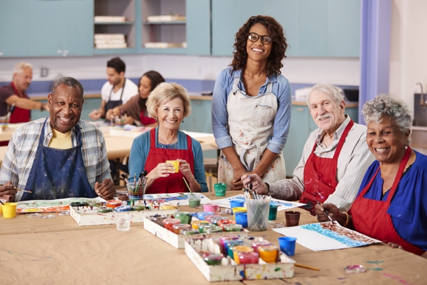 A group of older people painting with watercolours