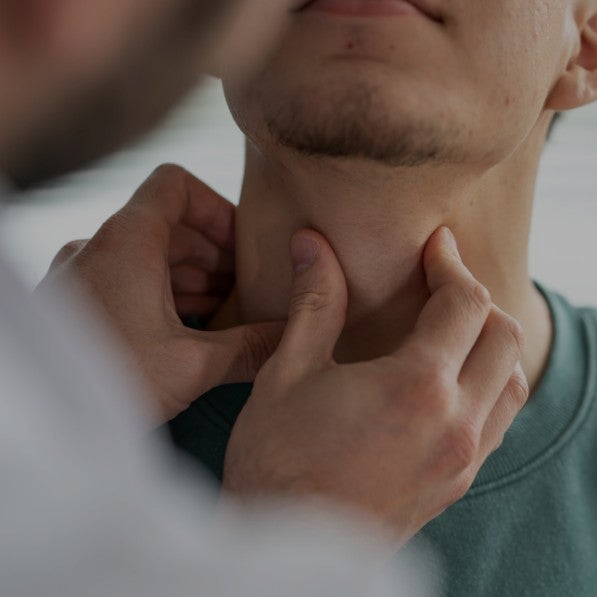 A doctor examining someone's throat