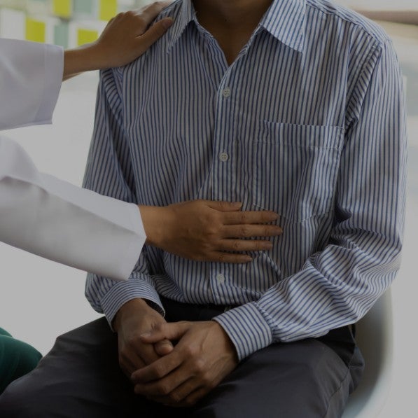 A doctor patting a patient's belly