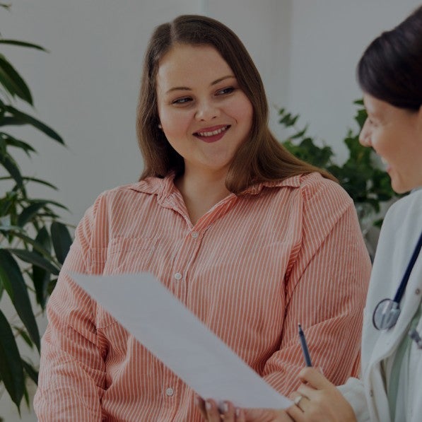 A doctor reading off a chart to a patient