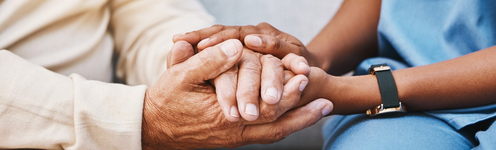 Nurse holding patients hand