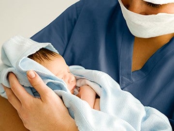 Nurse holding newborn