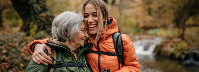 Older woman and younger woman hugging