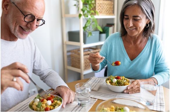 A couple eating healthy at a dinner table