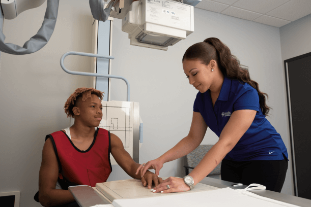 young man getting an x-ray of hand 